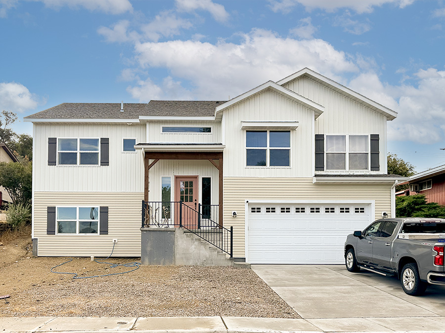 Charming 2-story home The Nash floorpan - neutral siding with accenting muted salmon front door.